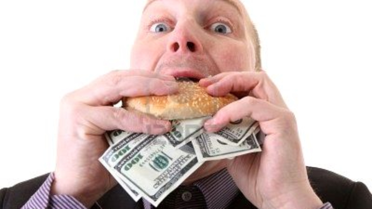 6095924-greed-businessman-eating-money-man-eat-dollars-in-display-of-avarice-isolated-on-white-1